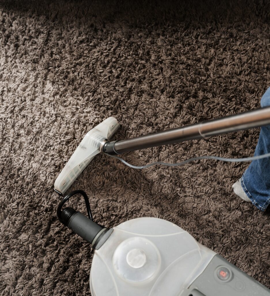 housekeeper is extracting dirt from carpet using dry cleaning extractor mop machine cleaner girl is cleaning carpet with mop extraction machine dry clean upholstered furniture