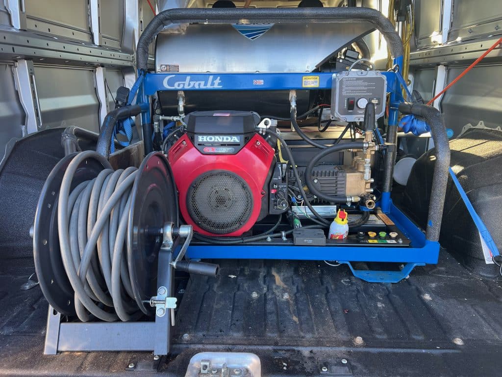 Back of a pickup truck with cleaning machine